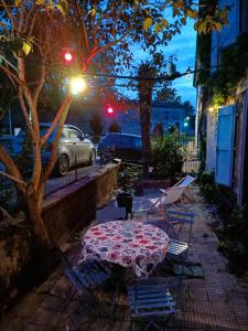eine Terrasse mit einem Tisch und Stühlen in der Nacht in der Unterkunft L'écrin in Lacroisille