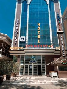 a building with a sign on the front of it at Khujand Star in Khujand