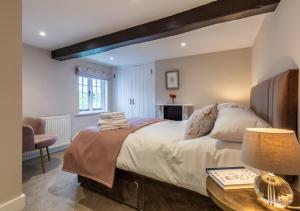 a bedroom with a large bed and a table at The Farmhouse at Marrington Estate in Chirbury