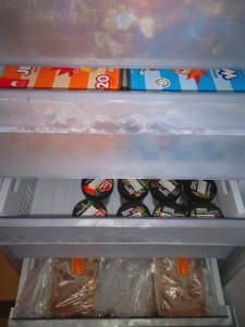 a refrigerator shelf filled with lots of food and drinks at Apartment Sončni Mokec in Rečica ob Savinji +35 photos
