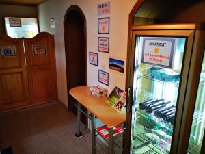 a shop with a refrigerator and a table in it at Apartment Sončni Mokec in Rečica ob Savinji