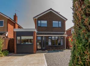 a brick house with a garage at Styche View, beautiful 4 bedroom home available in Market Drayton