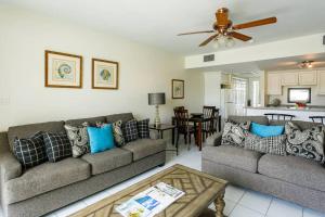 a living room with two couches and a table at Beach Living at Island Pine Villas BLP in George Town