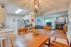 a kitchen and dining room with a wooden table at Riverfront family-friendly condo in Avon