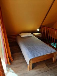 a small bed in a room with a staircase at Ceļinieks in Babīte