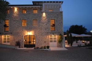 a large stone building with lights on at Relais Ca' Morenica in Valeggio sul Mincio