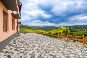 una strada acciottolata di fronte a un edificio di Шепіт Лісу a Bukovel