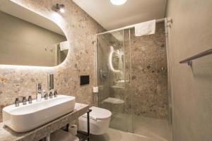 a bathroom with a sink and a shower at Hotel Alexander in Krakow