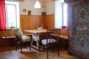 uma sala de jantar com uma mesa de madeira e cadeiras em Monika am Masenberg em Vorau