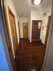 a hallway with a tile floor and a room with a door at Sunshine Faleza Nord in Constanţa