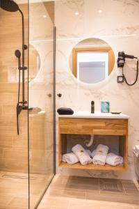 a bathroom with a shower and a sink at Aurelia Luxury Apartments in Agios Ioannis Kaspaka