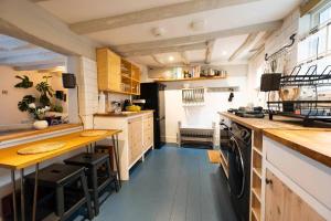 a kitchen with a counter and a table in it at Linden Grove - 2 Bed City Centre Cottage in Kent