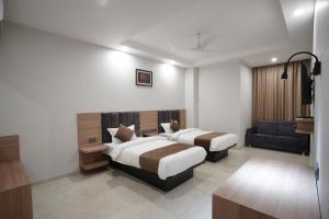 A bed or beds in a room at Hotel Krishna Inn
