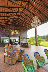 a large room with chairs and a chandelier at Kanasu The Resort - Cottages & Farm House in Udupi