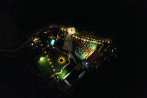 an overhead view of a park with lights at night at Kanasu The Resort - Cottages & Farm House in Udupi