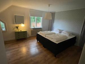 - une chambre avec un grand lit et du parquet dans l'établissement Semesterhus i Småland, à Söderåkra