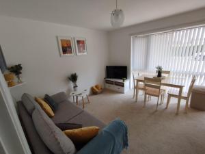 a living room with a couch and a table at Sunset Retreat - Hunstanton in Hunstanton