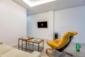 a living room with a couch and a chair and a table at Casa Lola Fuengirola centro in Fuengirola