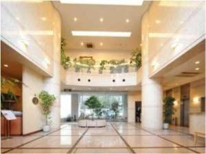 a large building with a lobby with plants on the ceilings at Bright Park Hotel - Vacation STAY 67876v in Kochi