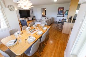 a dining room and living room with a table and chairs at Nord Riverside in Rovaniemi