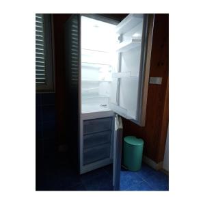 an empty refrigerator with its door open in a room at 2 Apartm for rent in Korcula in Korčula