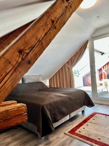 um quarto com uma cama e uma grande janela em Wohnen über den Dächern von Bregenz em Bregenz