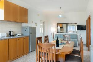 a kitchen and dining room with a table and chairs at Elli's apartment 1 in Antimácheia