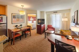a hotel room with a living room with a bed at Residence Inn by Marriott Fredericksburg in Fredericksburg