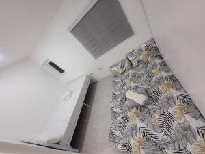 a bedroom with a bed with a zebra patterned wall at Budget friendly yet cozy staycation in Calapan