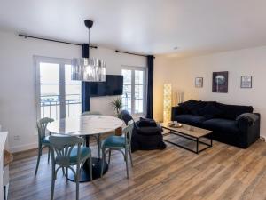 a living room with a table and a couch at Résidence GABRIELLE in Le Havre