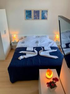 a bedroom with a blue bed with two people on it at Apartament Esperanza in Sunny Beach