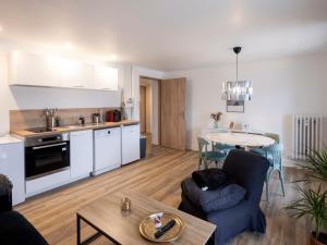 a kitchen and a living room with a table at Résidence GABRIELLE in Le Havre