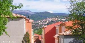 a view of a town with mountains in the background at Lagrange Vacances Domaine de Fayence in Fayence
