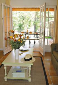 a living room with a table with a vase of flowers at Lagrange Vacances Domaine de Fayence in Fayence