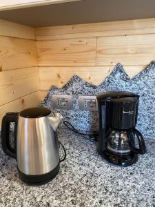 a coffee maker and a tea kettle on a counter at Bella Italia chalet in Massino Visconti