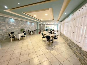 a restaurant with tables and chairs in a room at BlackStone.Shkodra in Shkodër +18 photos