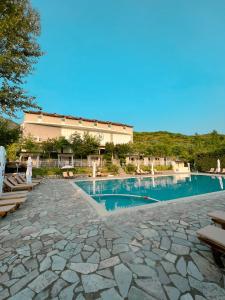 a large swimming pool with a building in the background at BlackStone.Shkodra in Shkodër