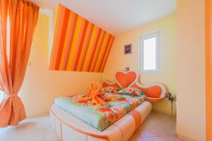 a bedroom with a bed with an orange crib at Boutique Guest House 'Sofia' in Nesebar