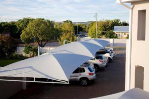 a group of cars parked in a parking lot with a tent at Lion Lodge in Bloemfontein