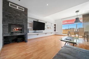 a living room with a fireplace and a tv at Villa Sabela in Segur de Calafell