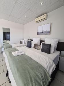 a room with two large beds in a room at Lion Lodge in Bloemfontein