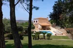 an external view of a house with a swimming pool at Malvazia Grand Estate, 4acre Immersed in Greenery, By ThinkVilla in Kermoútsi