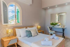 a bedroom with a bed with a desk and a window at Amor Villa in Laganas +34 photos