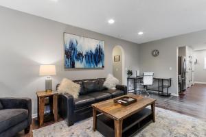 a living room with a couch and a table at New Pet Friendly Walking Distance to Lake Front in Lake Geneva