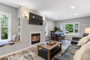 a living room with a couch and a fireplace at New Pet Friendly Walking Distance to Lake Front in Lake Geneva