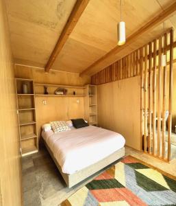 a bedroom with a bed in a wooden room at Casa Raposa Lodges - Terrace Mountain View in Manteigas