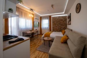 sala de estar con sofá y dormitorio en Lux Apartman Sunce en Jagodina