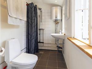 a bathroom with a toilet and a sink at 8 person holiday home in Holbæk-By Traum in Holbæk +34 photos
