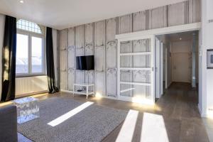 ein Wohnzimmer mit einem TV an der Wand in der Unterkunft Smartflats - Meir Antwerp in Antwerpen