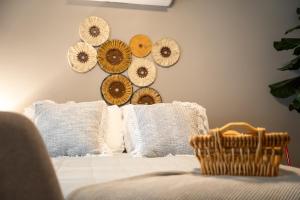 a room with a bed with pillows and plates on the wall at Casa San Marcos UNO in Mexicali